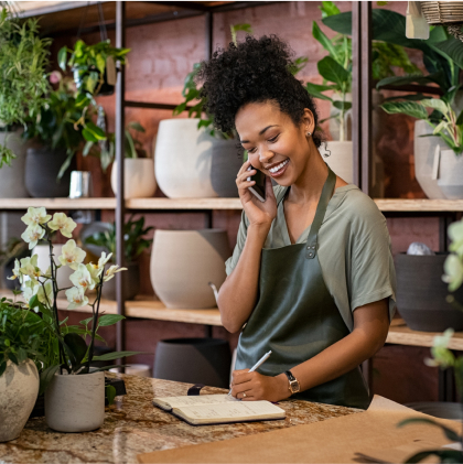 Woman working in a plant shop talking on a phone