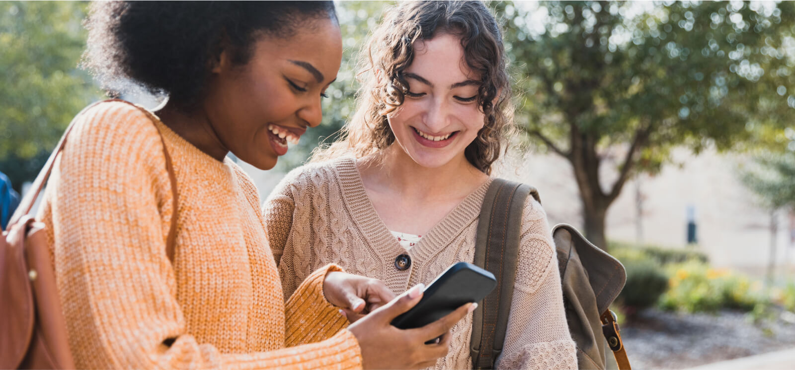 Two young women looking at a smartphone