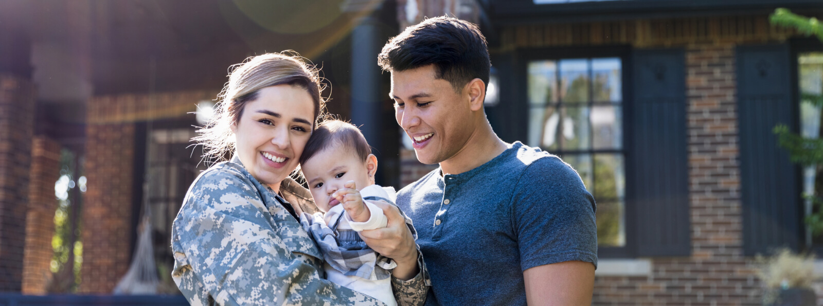 A family standing together outside a house