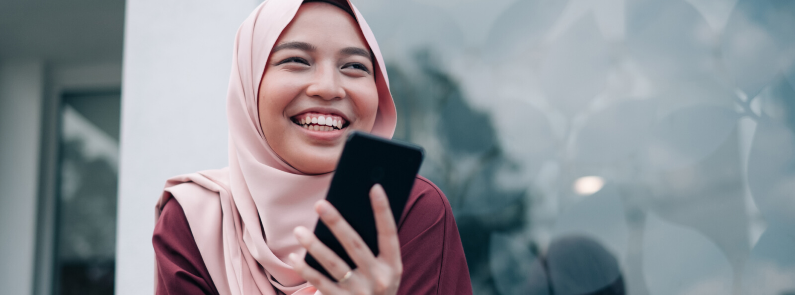 Woman smiling and holding a smartphone