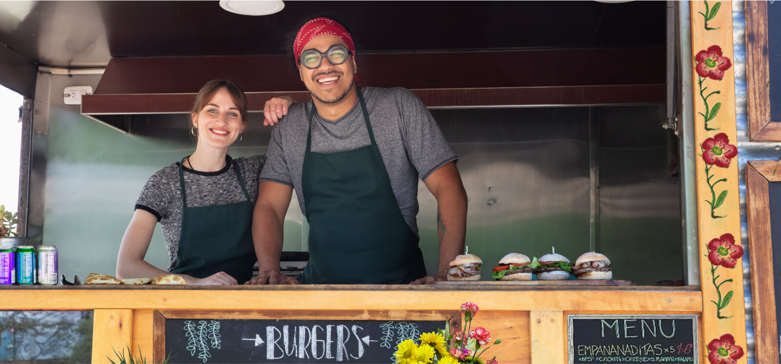 Two workers inside of a food truck